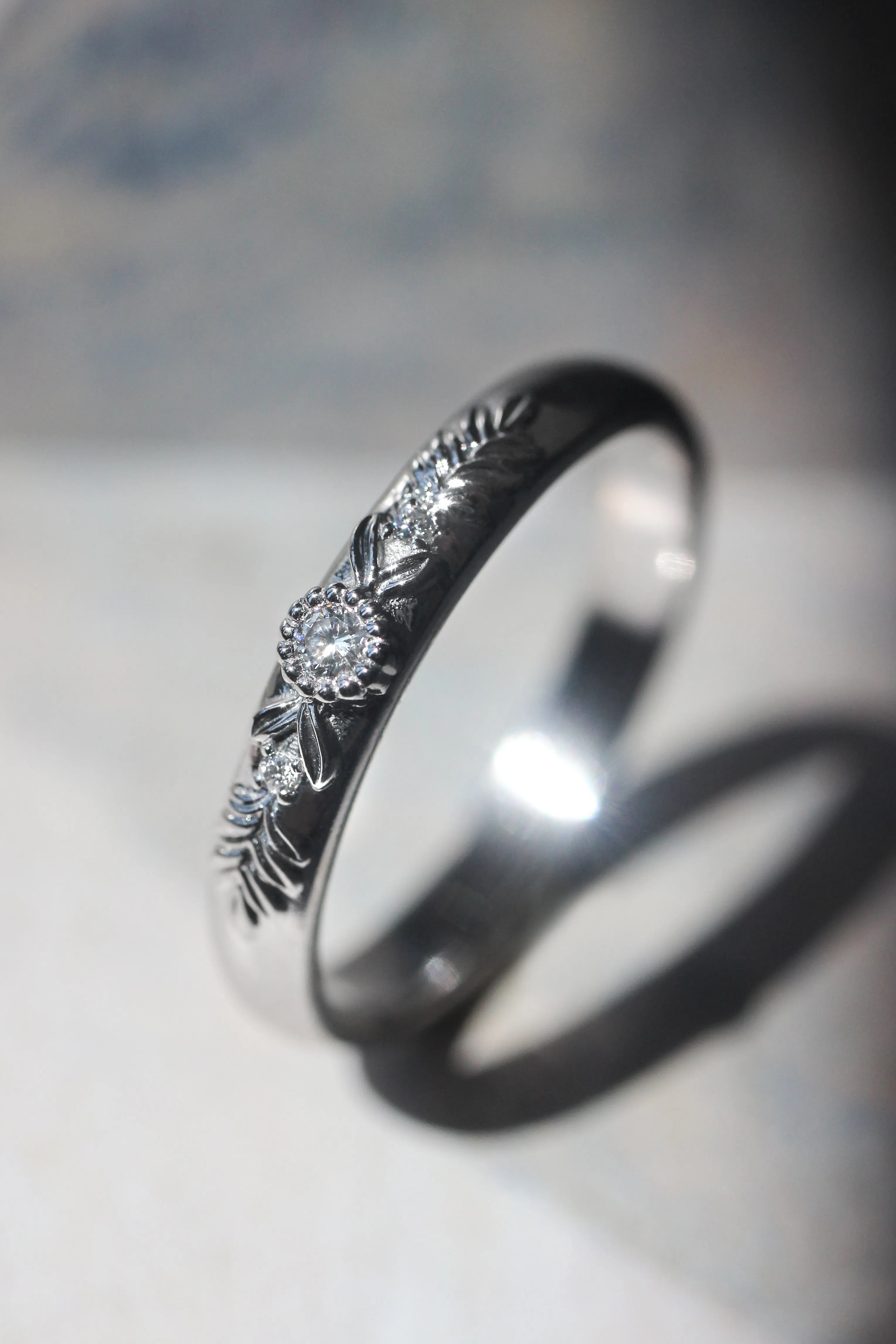 White gold wedding band with three diamonds, wreath ring