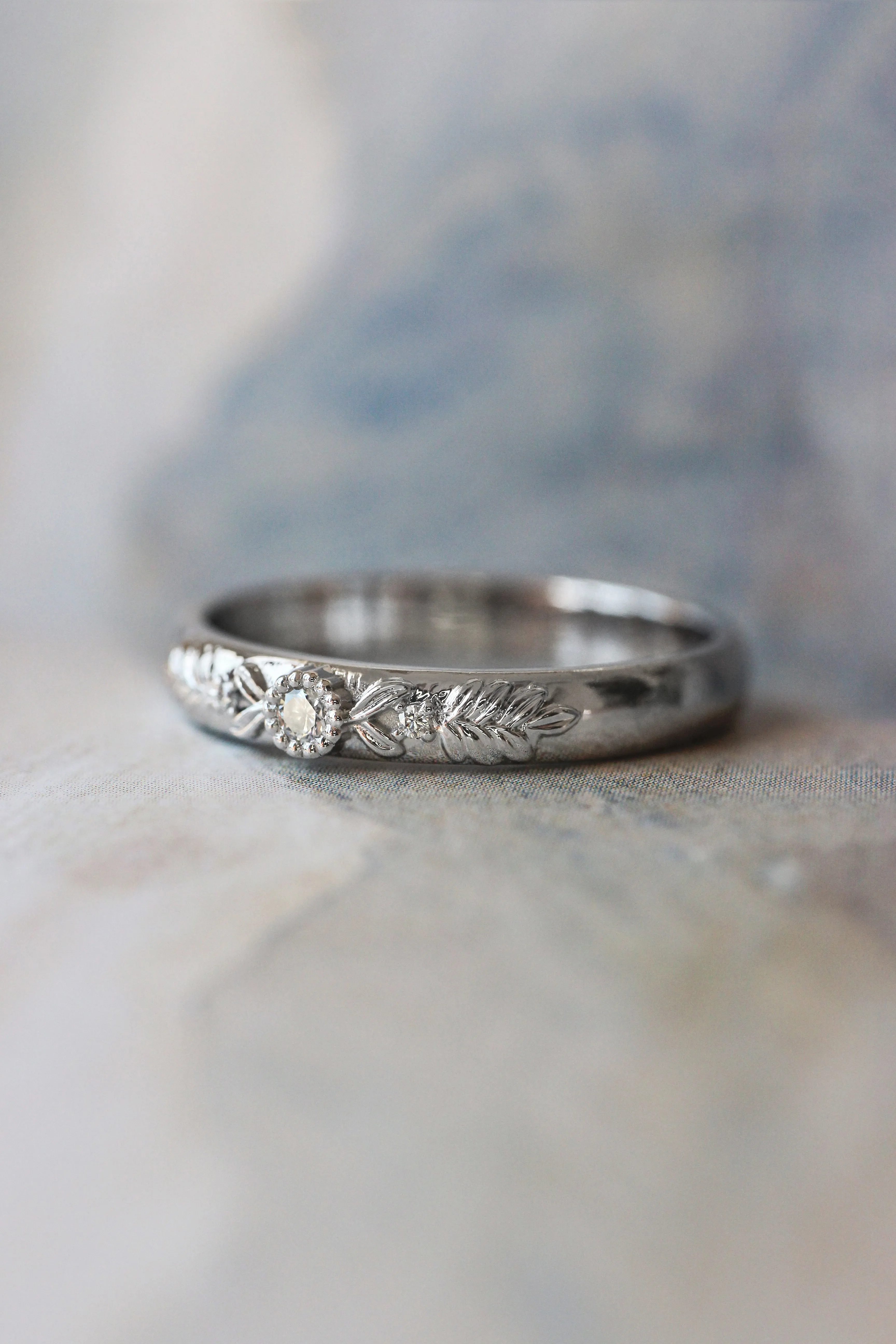 White gold wedding band with three diamonds, wreath ring